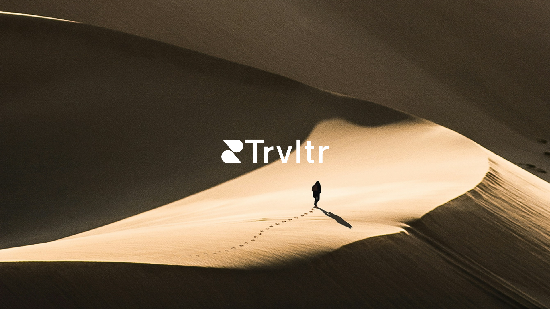 Man walking on dunes with Trvltr logo overlaying the picture